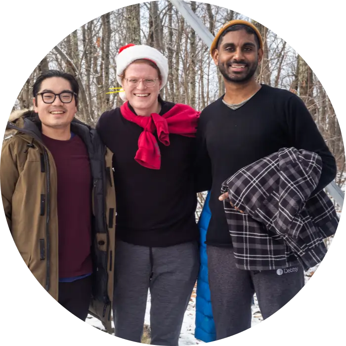 3 people smiling and standing outside